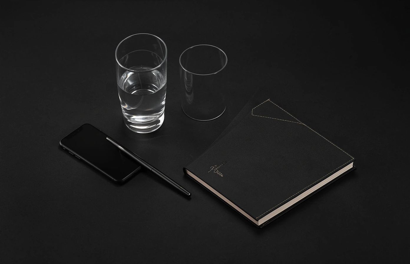 Minimal composition with drinks, phone, and notebook